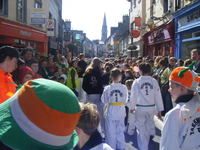 students march through the crowded streets of Ennis